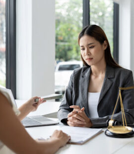 A trust dispute attorney meeting with a client to review a trust instrument and determine if it was set up in accordance with trust law.