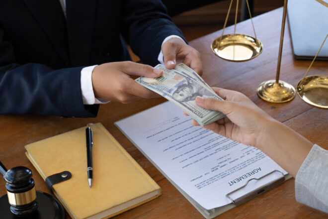 A trustee and beneficiary exchanging funds in an instance of fraud, one of many occasions you may need to hire a will contest and trust fraud attorney in California.
