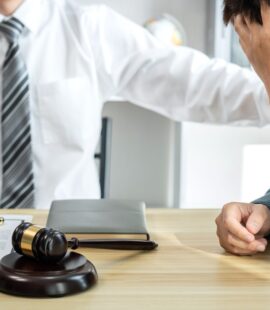 A California trust litigation lawyer meeting with a beneficiary who is pursuing legal action to protect his inheritance because a trustee breached his or her trustee duties in California.