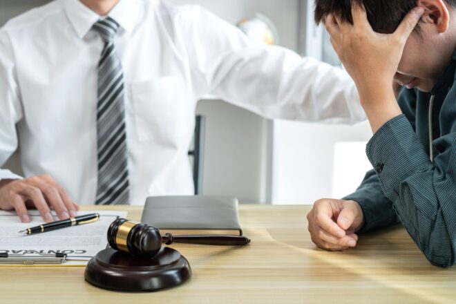 A California trust litigation lawyer meeting with a beneficiary who is pursuing legal action to protect his inheritance because a trustee breached his or her trustee duties in California.