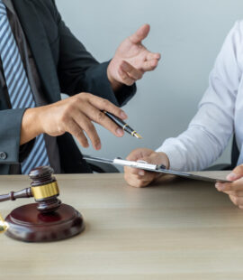 Trust litigation lawyers in Orange County discussing a case and giving their client good counsel to ensure they don’t end up on the wrong side of the answer to, Who has to pay trust dispute legal fees?