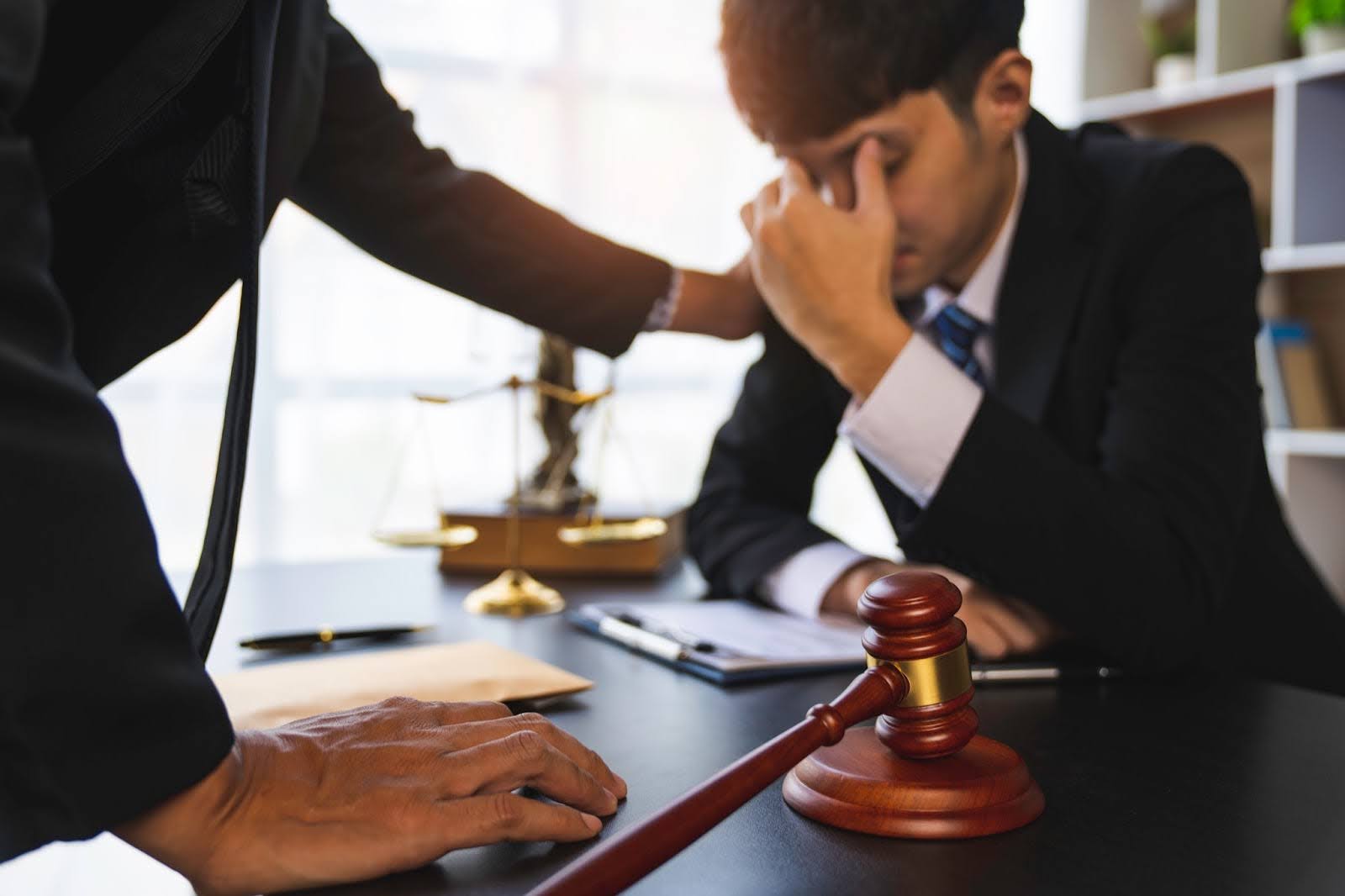 A lawyer comforting a beneficiary and helping them learn how to invalidate a trust to defend their inheritance.