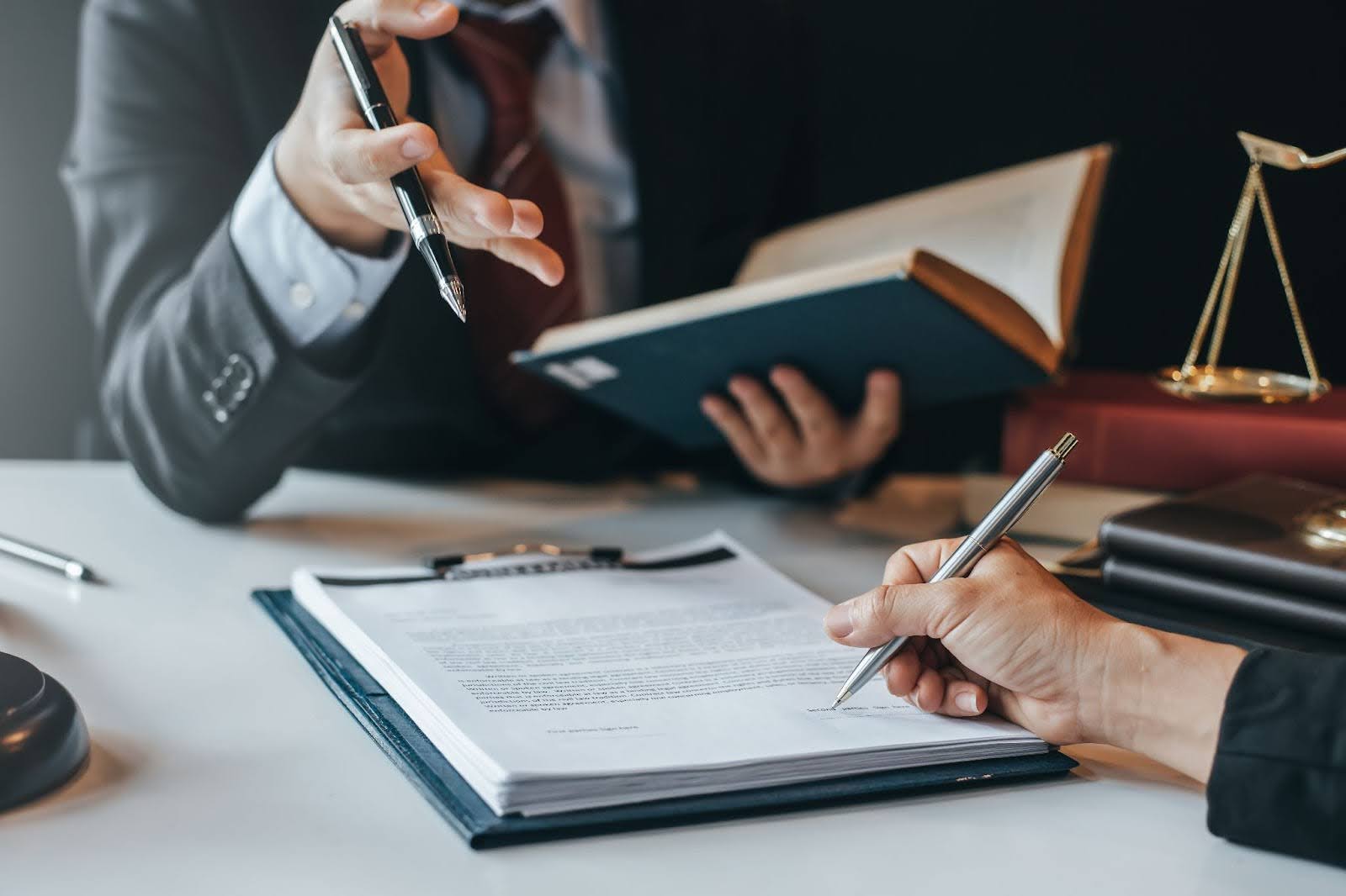 A California trust litigation attorney discussing a case with a colleague and reviewing probate code to answer their client’s question: Can a trustee refuse to act?