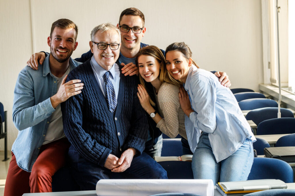 Multiple generations of a family smiling with relief after answering the question, Can you inherit a family business?